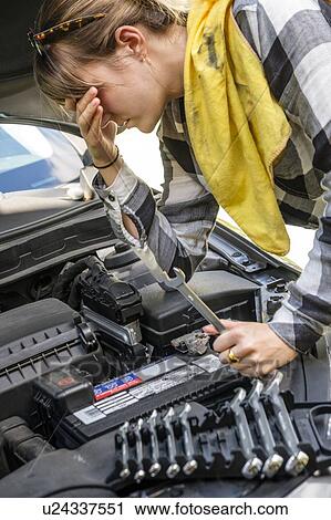 Frustrated woman repairing car View Large Photo Image Stock Image - Frustrated woman repairing car. Fotosearch
