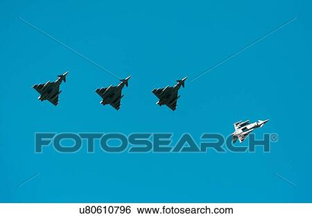 Stock Photograph - German Eurofighter Typhoon fighter planes taking part in NATO exercise Frysian flag, low angle against blue sky, Netherlands. Fotosearch