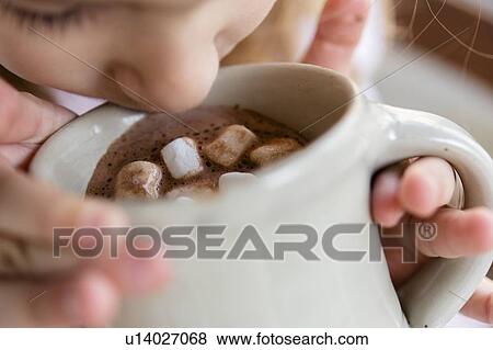 Girl drinking hot chocolate with marshmallows View Large Photo Image Stock Photo - Girl drinking hot chocolate with marshmallows. Fotosearch