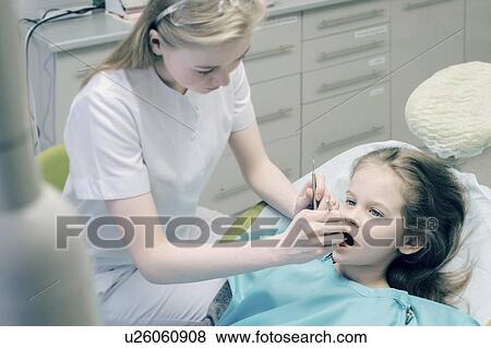 Girl during dentist examination View Large Photo Image Stock Photo - Girl during dentist examination. Fotosearch