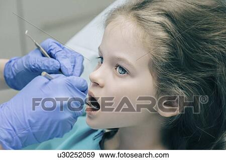 Girl during dentist examination View Large Photo Image Stock Photo - Girl during dentist examination. Fotosearch