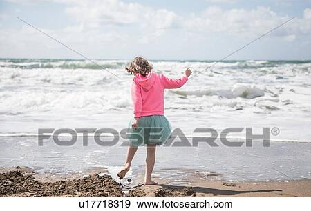 Stock Photo - Girl exploring beach. Fotosearch