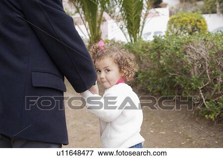 Girl holding her father's hand View Large Photo Image Stock Photo - Girl holding her father's hand. Fotosearch