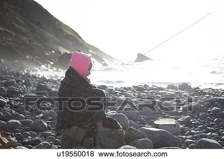 Girl in deep thought on rocks by sea View Large Photo Image Stock Photo - Girl in deep thought on rocks by sea. Fotosearch
