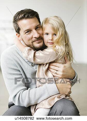 Girl sitting on her father's lap View Large Photo Image Stock Image - Girl sitting on her father's lap. Fotosearch