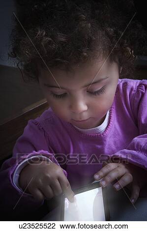 Stock Image - Girl using smart phone. Fotosearch