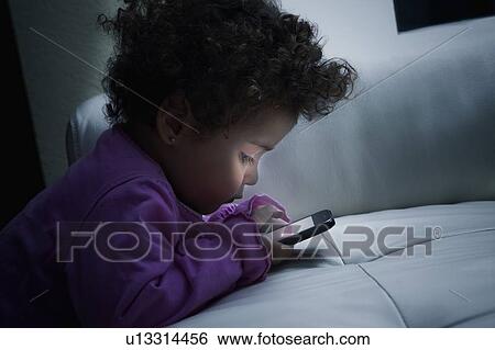 Girl using smart phone View Large Photo Image Stock Photograph - Girl using smart phone. Fotosearch