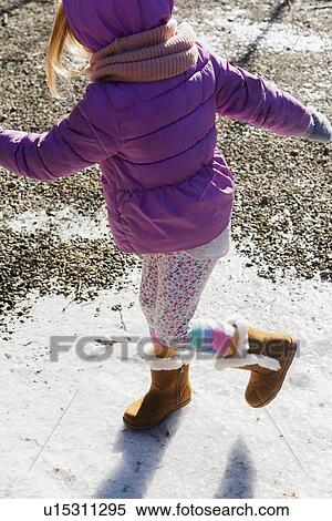 Girl wearing purple coat walking on snow View Large Photo Image Stock Photography - Girl wearing purple coat walking on snow. Fotosearch