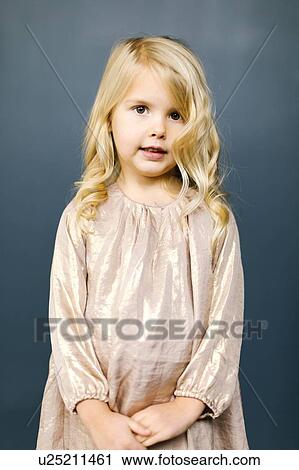 Stock Image - Girl wearing taupe dress. Fotosearch