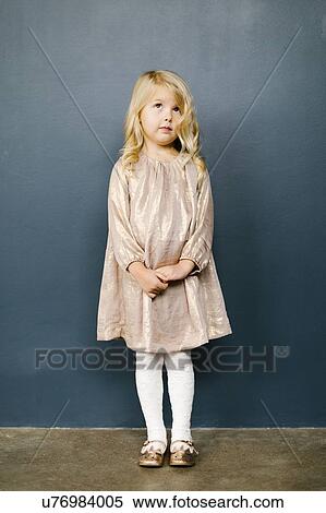 Stock Photography - Girl wearing taupe dress. Fotosearch