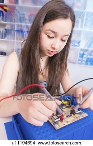 Girl working on electronics project. View Large Photo Image Picture - Girl working on electronics project.. Fotosearch