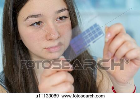 Stock Photo - Girl working on electronics project.. Fotosearch