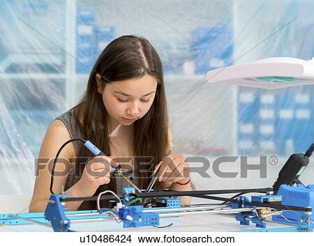 Picture - Girl working on robotics project.. Fotosearch