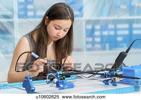 Stock Photography - Girl working on robotics project.. Fotosearch