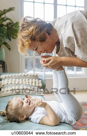 Grandmother playing with granddaughter View Large Photo Image Picture - Grandmother playing with granddaughter. Fotosearch