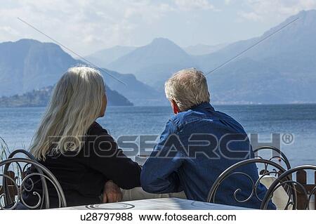 Gray haired couple sitting by Lake Como in Lombardy, Italy View Large Photo Image Stock Photo - Gray haired couple sitting by Lake Como in Lombardy, Italy. Fotosearch