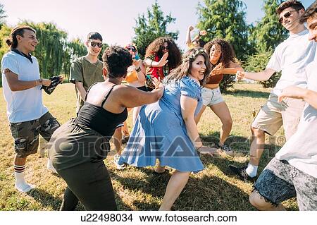 Group of friends dancing in park View Large Photo Image Picture - Group of friends dancing in park. Fotosearch