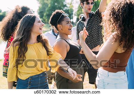 Group of friends dancing in park View Large Photo Image Stock Image - Group of friends dancing in park. Fotosearch
