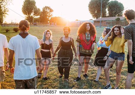 Group of friends dancing in park View Large Photo Image Stock Photo - Group of friends dancing in park. Fotosearch