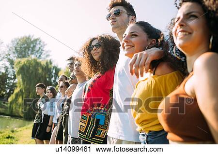 Group of friends posing in park View Large Photo Image Stock Image - Group of friends posing in park. Fotosearch