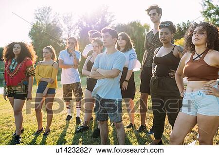 Group of friends posing under hot sun in park View Large Photo Image Stock Photo - Group of friends posing under hot sun in park. Fotosearch