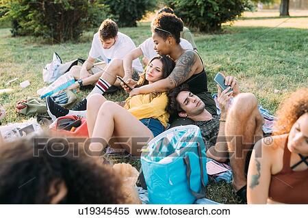 Group of friends relaxing at picnic in park View Large Photo Image Stock Photography - Group of friends relaxing at picnic in park. Fotosearch