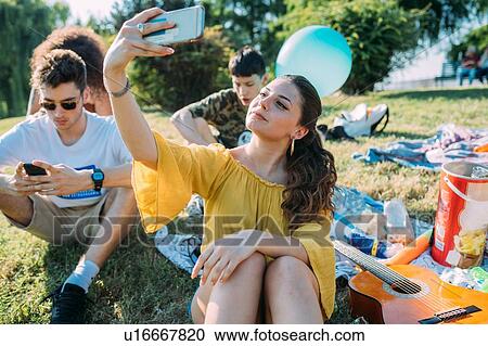 Group of friends relaxing, taking selfie at picnic in park View Large Photo Image Stock Image - Group of friends relaxing, taking selfie at picnic in park. Fotosearch
