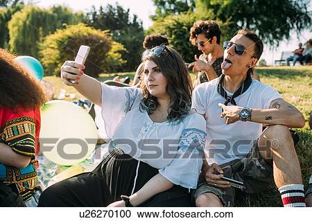Group of friends relaxing, taking selfie at picnic in park View Large Photo Image Stock Image - Group of friends relaxing, taking selfie at picnic in park. Fotosearch