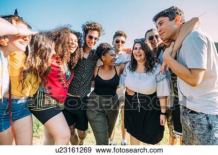 Group of friends standing in semi-circle in park View Large Photo Image Stock Photo - Group of friends standing in semi-circle in park. Fotosearch