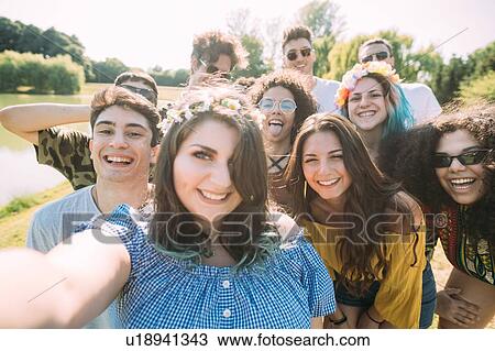 Group of friends taking selfie in park View Large Photo Image Stock Image - Group of friends taking selfie in park. Fotosearch