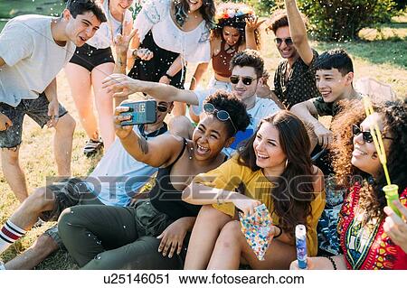 Group of friends taking selfie in park View Large Photo Image Stock Image - Group of friends taking selfie in park. Fotosearch