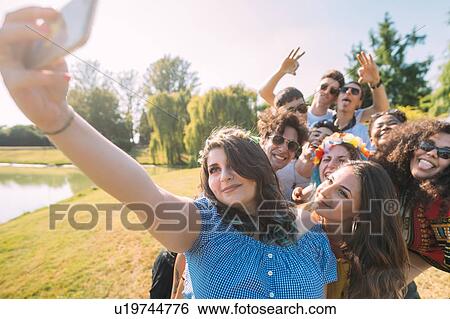 Group of friends taking selfie in park View Large Photo Image Stock Photograph - Group of friends taking selfie in park. Fotosearch