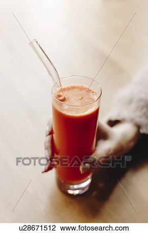 Hand of woman holding carrot juice View Large Photo Image Stock Image - Hand of woman holding carrot juice. Fotosearch