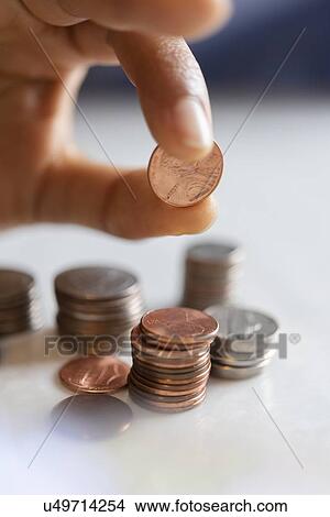 Hand of woman stacking coins View Large Photo Image Picture - Hand of woman stacking coins. Fotosearch