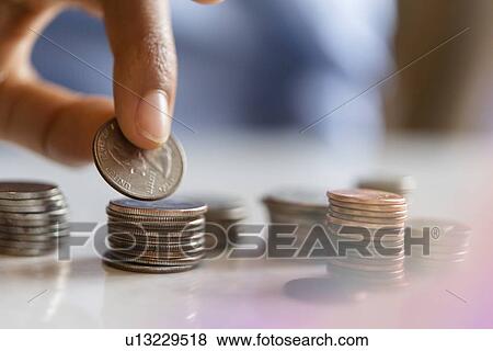 Hand of woman stacking coins View Large Photo Image Stock Photo - Hand of woman stacking coins. Fotosearch