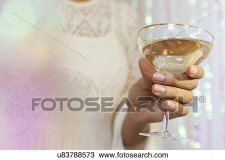Hand of young woman holding glass of white wine View Large Photo Image Stock Image - Hand of young woman holding glass of white wine. Fotosearch