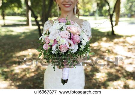 Hands of bride holding bouquet View Large Photo Image Stock Photo - Hands of bride holding bouquet. Fotosearch