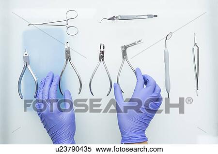 Hands of dental assistant wearing rubber gloves with dental equipment View Large Photo Image Stock Photography - Hands of dental assistant wearing rubber gloves with dental equipment. Fotosearch