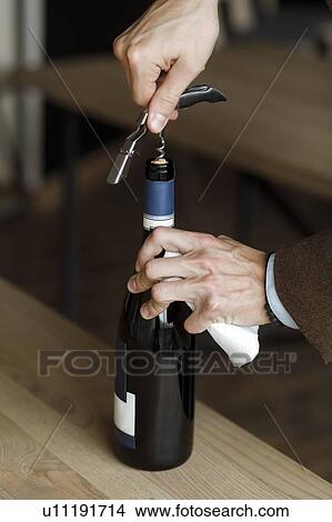 Hands of man opening bottle of wine View Large Photo Image Picture - Hands of man opening bottle of wine. Fotosearch