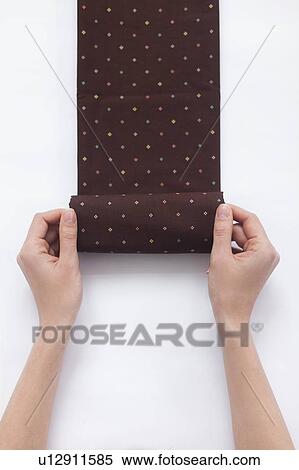 Hands of woman folding brown fabric View Large Photo Image Stock Photography - Hands of woman folding brown fabric. Fotosearch
