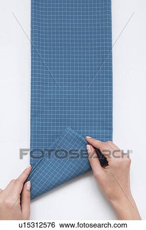 Hands of woman folding checked blue fabric View Large Photo Image Stock Photograph - Hands of woman folding checked blue fabric. Fotosearch