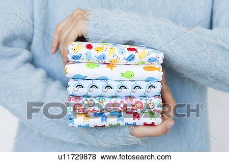 Hands of woman holding animal print fabrics View Large Photo Image Stock Photo - Hands of woman holding animal print fabrics. Fotosearch