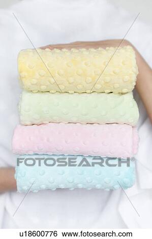 Stock Photograph - Hands of woman holding pastel color fabrics. Fotosearch