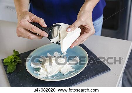 Hands of woman shaving ricotta View Large Photo Image Stock Image - Hands of woman shaving ricotta. Fotosearch