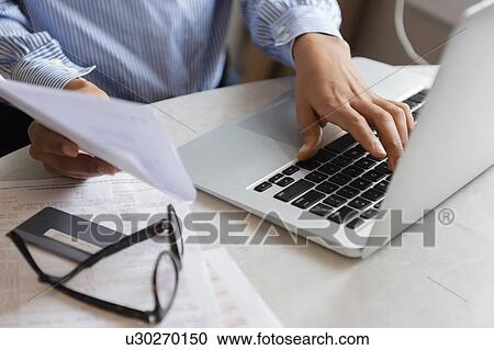 Stock Image - Hands of woman typing on laptop. Fotosearch
