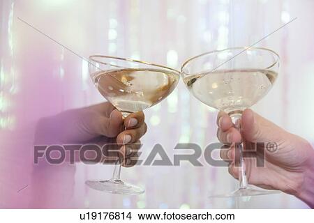 Picture - Hands of women making celebratory toast. Fotosearch