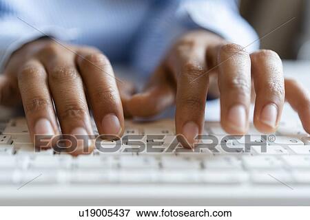 Stock Photo - Hands of young woman typing on computer keyboard. Fotosearch