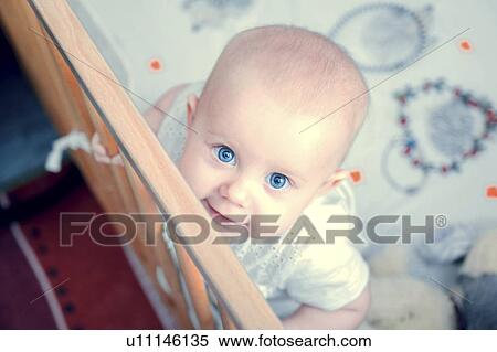 Stock Photography - High angle view of baby in crib. Fotosearch