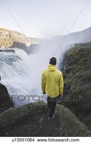 Hiker by Gullfoss waterfall in Iceland View Large Photo Image Picture - Hiker by Gullfoss waterfall in Iceland. Fotosearch