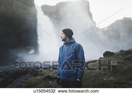 Stock Image - Hiker by Haifoss waterfall in Iceland. Fotosearch